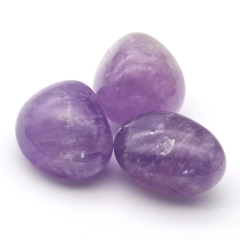 Drei fliederfarbene Amethyst-Trommelsteine als Beispiel für geschliffene Edelsteine im Edelstein Lexikon Amethyst